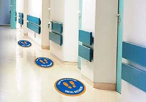 Photo of hallway with social distancing decals positioned 6 feet apart